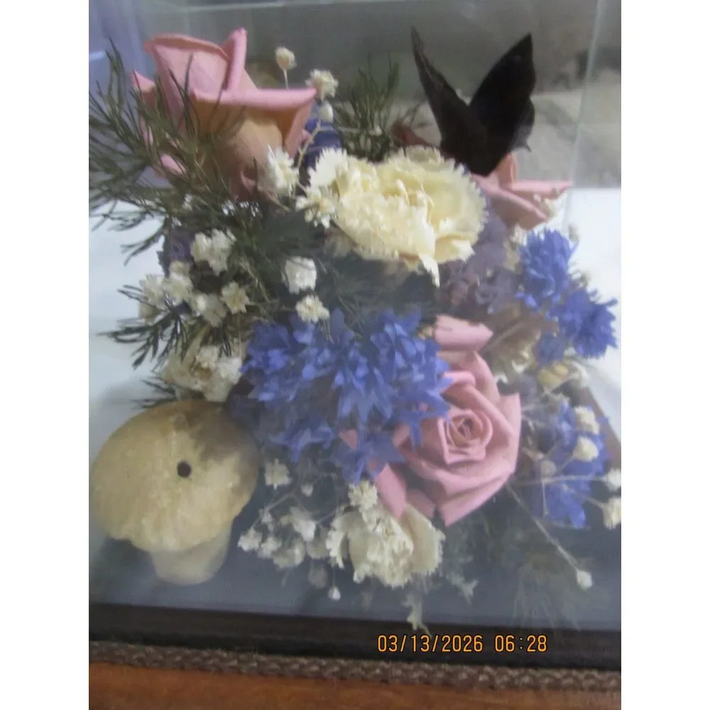 Vintage dried flower arrangement in glass with wood base butterfly mushrooms